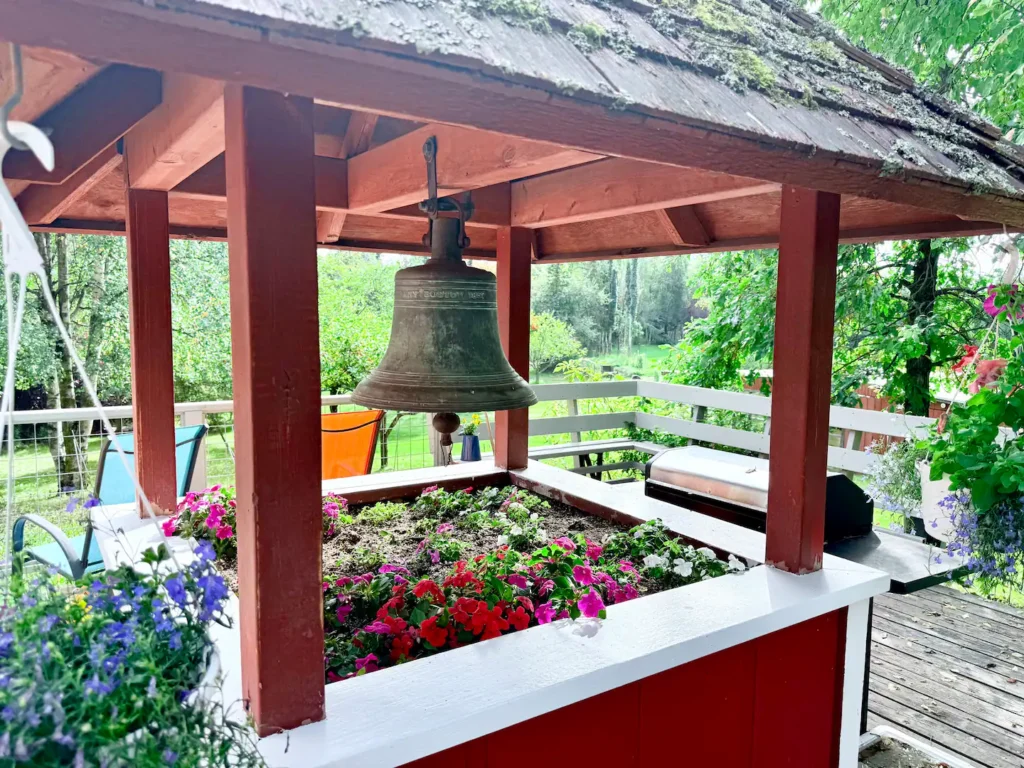 a bell hanging in a flower box
